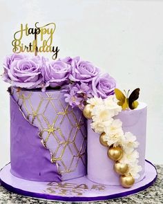 there is a purple cake with flowers on it