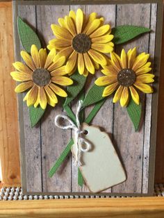 a card with sunflowers and a tag tied to it