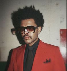 a man in a red suit and sunglasses