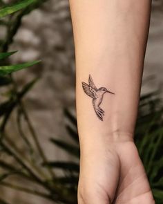 a small hummingbird tattoo on the wrist