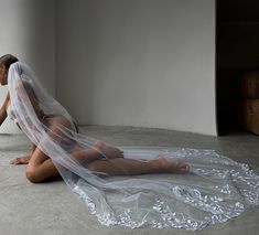 a woman sitting on the floor wearing a veil