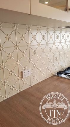 a stove top oven sitting inside of a kitchen next to a wooden table and wall