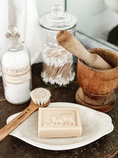 a wooden brush and soap on a table