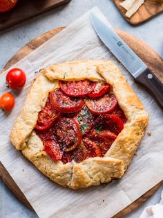 a tomato pie on a cutting board with a knife