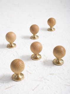 six wooden knobs are arranged in the shape of an eight - sided ball on a white surface