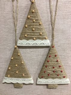 three christmas tree ornaments hanging on a wall