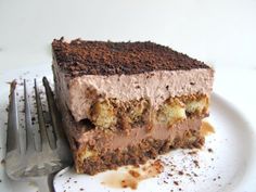 a piece of cake sitting on top of a white plate next to a knife and fork