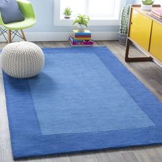 a blue rug with a white ball on it in the middle of a living room