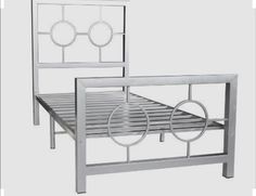 a metal bed frame with two circles on the headboard and foot board, against a white background