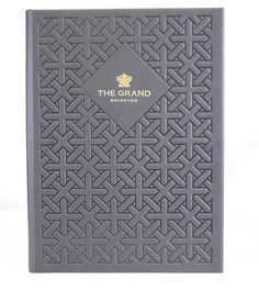 the grand book with an intricate design on it's cover is sitting in front of a white background