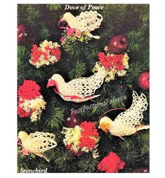 crochet christmas tree ornaments with birds and berries on them in the shape of doves