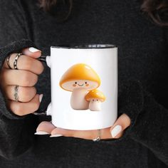 a woman holding a coffee mug with a mushroom on it's front and side