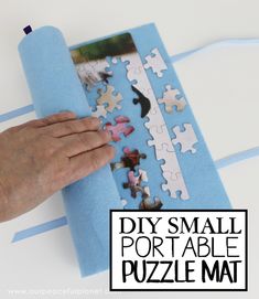 a person is placing puzzle pieces on a piece of blue paper with the words diy small portable puzzle mat