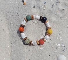 This Beachy Boho Shell Bead Bracelet is the perfect accessory for any beach lover. Made with natural shells, this bracelet adds a touch of bohemian style to any outfit. With its unique design and coastal-inspired materials, this bracelet is a must-have for those looking to add a beachy vibe to their look. Elastic Bracelet Beads are Ceramic, Coconut Shell, and Shell 10mm-8mm Model is wearing a size 6 inch, Please measure your wrist before ordering. We recommend adding half of an inch to your wrist size for a slightly fitted bracelet. If you want more play size up one inch. If you need a size not listed please reach out to us. Beachy Bracelets, Beach Jewelry Boho, Bracelets Boho, Boho Beachy, Beachy Boho, Beach Bracelets, Beach Lover, Bohemian Bracelets, Shell Bracelet