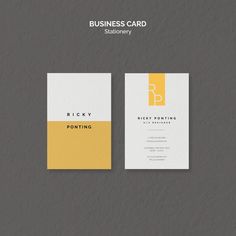 two business cards with yellow and white designs on them, one has a letter in the middle