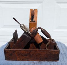 some tools are in a wooden box on a table