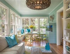 a living room filled with lots of furniture next to a dining room table and chairs