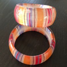 Striped Acrylic Bracelets Apx. 1.25” Wide. Great Paired Together Or With Others! Priced Per Bracelet. Red Plastic Bracelet Jewelry, Vibrant Red Bracelets For Gift, Trendy Orange Plastic Jewelry, Trendy Red Plastic Bracelets, Trendy Red Plastic Bracelet, Adjustable Orange Bangle As Gift, Adjustable Orange Bangle For Gift, Retro Multicolor Bangle Bracelets, Retro Multicolor Bangle Jewelry