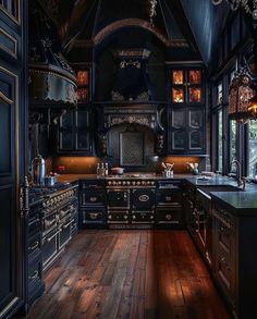 an old fashioned kitchen with wooden floors and black cabinets, wood flooring, and chandelier