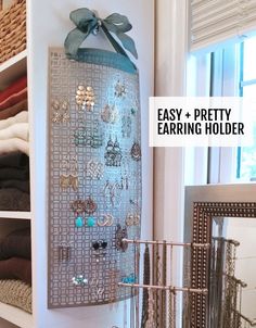 an easy and pretty earring holder is displayed on the wall next to a mirror