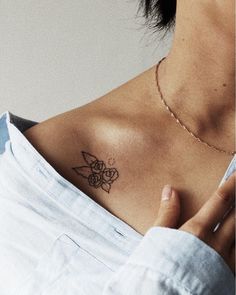 a woman with a small tattoo on her chest