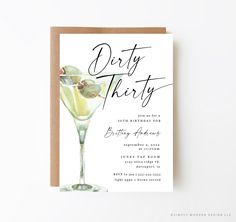 a card with the words dirty thirty written in cursive writing on it and a martini glass filled with lemons