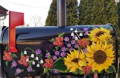 a mailbox decorated with sunflowers and flowers