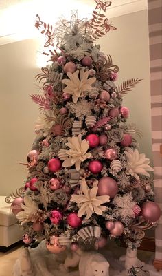 a christmas tree decorated with pink and silver ornaments