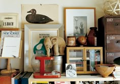 there are many items on the shelf in this room, including an elephant and other things