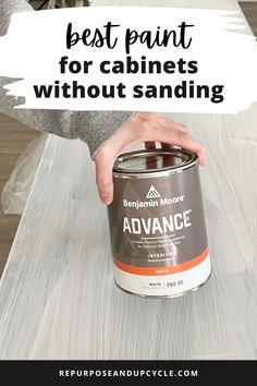 someone holding a paint can with the words best paint for cabinets without sanding