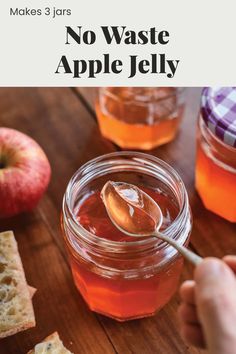 a person spooning honey out of a jar with bread and apples in the background