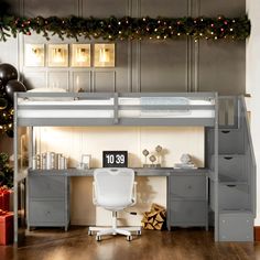 a loft bed with desk underneath it and christmas decorations on the wall behind it,