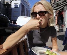 a woman sitting at a table eating food