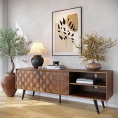 a living room with a wooden cabinet and vases on the table next to it