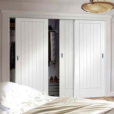 a bedroom with white closet doors and a chandelier