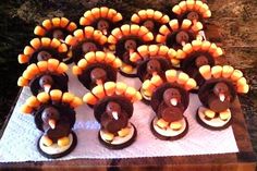 a table topped with lots of cupcakes shaped like turkeys