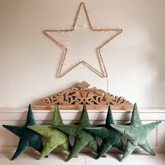 three green and white stars hanging on the wall