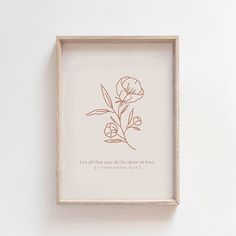 a wooden frame with a drawing of flowers on the wall above it that says, let all that you do be done in love