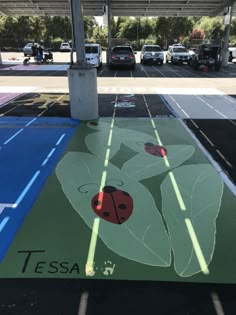 a parking lot with a painted ladybug on the ground