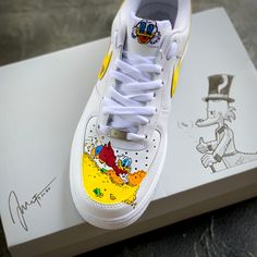 These customs are my original take on "Scrooge McDuck Money Bin"! Perfect lifestyle statement with your favorite Duckburg billionaire.  All customs are thoroughly prepped, spending several hours getting them ready. I use the top level industry standard Angelus Direct products. These paints allow the customs to hold up on a daily basis. I apply several sealing coats from LK Topcoat finishers. To insure the shoes are scratch and UV resistant. As well as waterproof and chemical resistant. Each cust Custom High-top Sneakers With Artwork, Scrooge Mcduck Money, Custom Dunks, Custom Sneakers Nike, Perfect Lifestyle, Custom Painted Shoes, Shoes Art, Scrooge Mcduck, Diy Canvas Wall Art