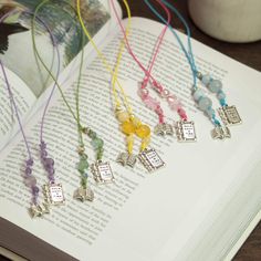 the book is open to show several different necklaces on it's pages,