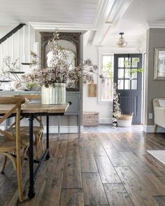 a dining room with wooden floors and white walls