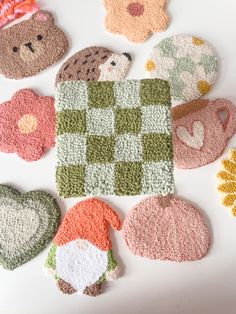 crocheted coasters with teddy bears and flowers on them are laid out in the shape of hearts