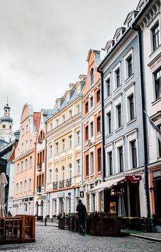 a cobblestone street lined with tall buildings