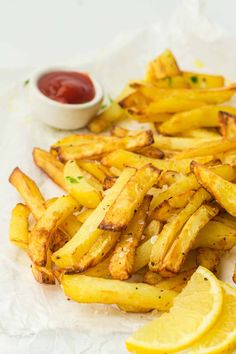 french fries with lemon wedges and ketchup on the side