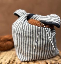 a stuffed animal in a bag with needles sticking out of it