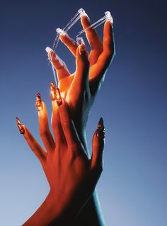 two hands are holding plastic objects in the air