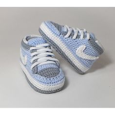 a pair of blue and white crocheted sneakers