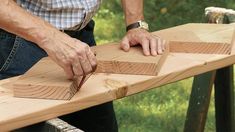 a man using a plane to cut wood