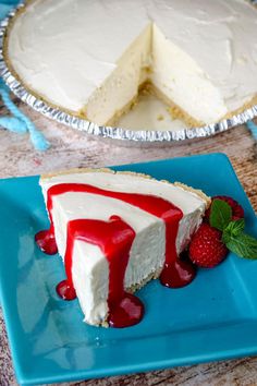 a piece of cheesecake on a blue plate next to a slice of strawberry pie